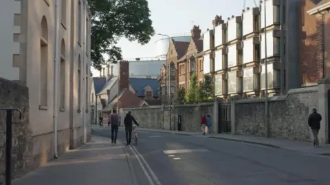 Issabella Orlando A view of lower Walton Street into Jericho. People are seen walking away from the camera. One person is pushing a bicycle.
