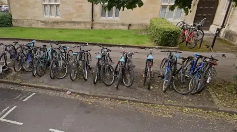 A row of bikes next to a road