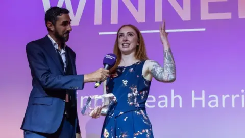 Tony Wooliscroft Leah Harris winning award