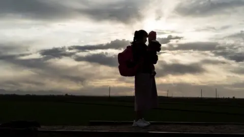 Reuters Woman holds child