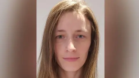 A head and shoulders picture of Kristine Sparane - she has blue eyes and light brown shoulder-length hair