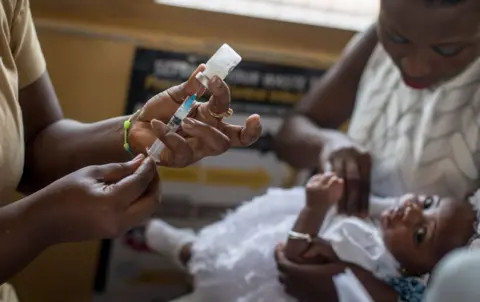 AFP A baby receives Malaria vaccine Mosquirix by a nurse at the maternity ward of the Ewin Polyclinic in Cape Coast, Ghana, on April 30, 2019. - Ewim Polyclinic on April 30, 2019 was the first in Ghana to roll out the Malaria vaccine Mosquirix