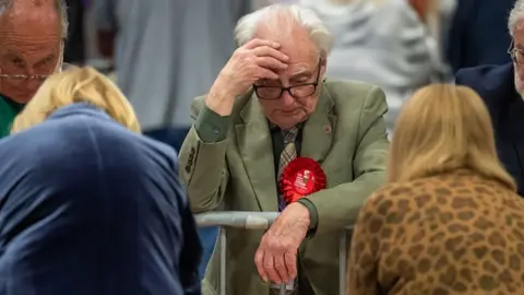 A Labour supporter looking at the vote count
