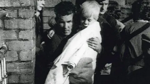 Jeff Edwards being carried out of the wreckage of Pantglas Junior School, Aberfan