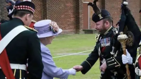 Scott Methven/PA Maj Scott Methven shaking hands with the Queen