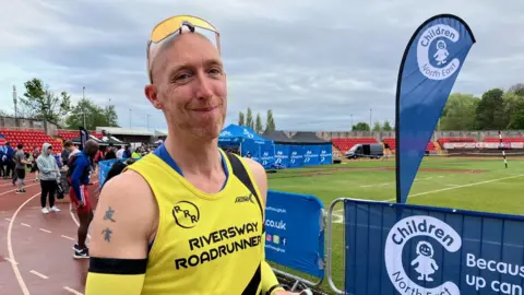 BBC A picture of Mark Potter who was running in his 175th marathon
