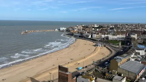 View from the top of Arlington House in Margate looking out to Margate Main Sands, the harbour arm, clocktower and Dreamland fin