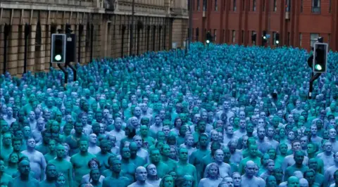 Reuters A sea of people painted all in blue standing in the streets of Hull.