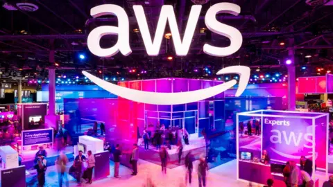 Getty Images Attendees walk through an expo hall at AWS re:Invent 2023, a conference hosted by Amazon Web Service in Las Vegas.
