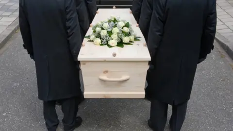 Getty Images Bearers with a coffin