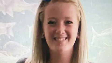 Family photo A young woman with long blonde hair smiling at the camera