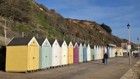 Malc McDonald A row of colourful beach huts on Bournemouth beach