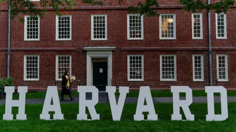 A students walks past a display on the Harvard University campus in Cambridge, Massachusetts.