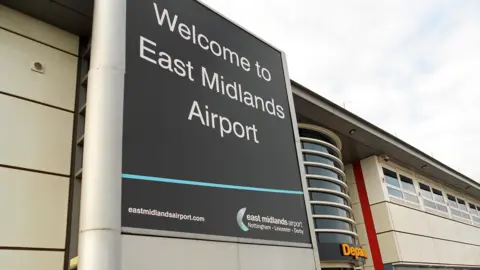 Getty Images Welcome to East Midlands Airport sign outside terminal building, Castle Donnington, England.
