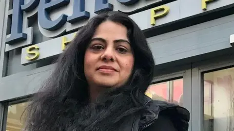 Saima Farhan and her daughter outside the centre. They both have long dark hair and are smiling