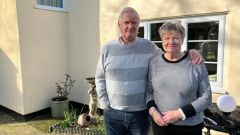 BBC Simon and Sally Hearse standing outside their home