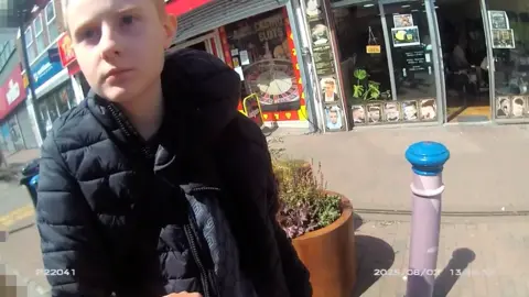 Counter Terrorism Police Alina Burns on a police body warn camera when she was arrested outside of a barber shop on East Street in Bedminster, Bristol. 