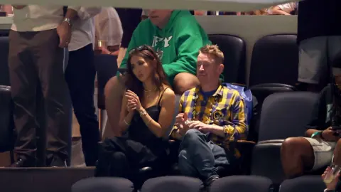 Getty Images Brenda Song and Macaulay Culkin sit next to one another