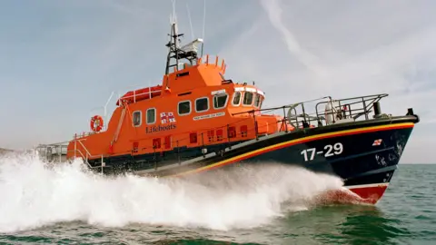 RNLI/Simon Culliford Richard Cox Scott on exercise in Falmouth Bay in February 2002. There is sea spray beside her but the sea is otherwise calm in the picture.