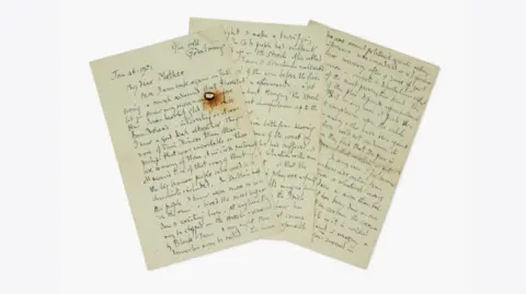 Courtesy Sotheby’s Photograph of letters sent by the mountaineer George Mallory to his mother. The image shows his handwriting on three sheets of paper.