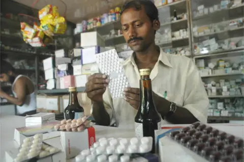 AFP An Indian pharmacy shop assistant counts a strip of tablets in Calcutta, 05 August 2003.