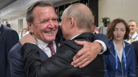 Getty Images Gerhard Schröder hugs President Putin, Moscow, 14 June 18