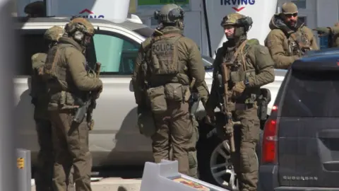 Getty Images Members of the Royal Canadian Mounted Police (RCMP) tactical unit confer after encountering the suspect in a deadly shooting rampage