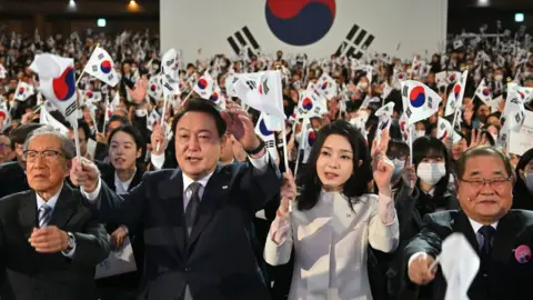 Getty Images South Korea's President Yoon Suk Yeol and his wife Kim Keon Hee at a national rally in March 2023