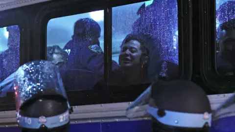 AFP via Getty Images Arrested protesters are seen inside a NYPD bus. Photo: 30 April 2024