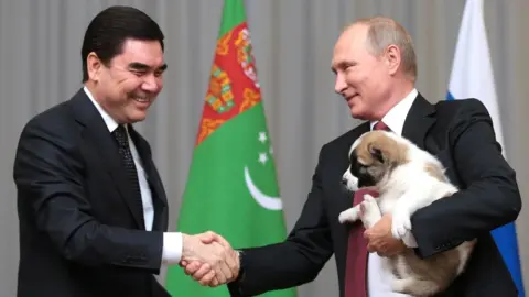 Anadolu Agency via Getty President Berdymukhamedov, Vladimir Putin and a puppy