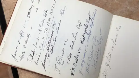 Hansons Autographs in a book