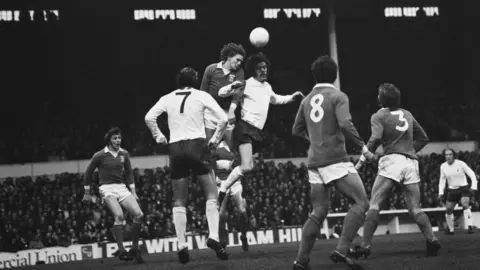 Getty Images Trevor Whymark heading the ball in a game against Tottenham Hotspur