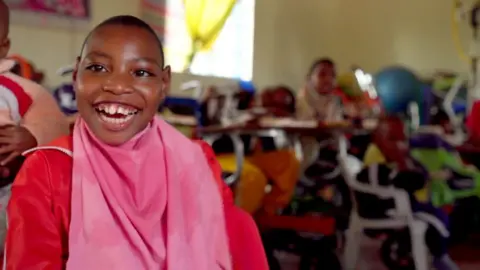 A child in the Kenyan home smiles