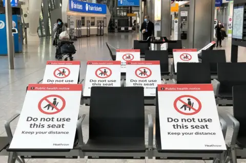 Getty Images Heathrow airport with seats showing 'do not use' signs on them