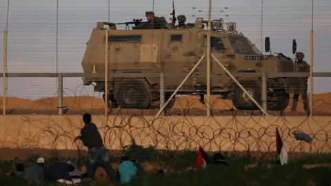 Reuters Israeli troops take position during a Palestinian protest at the Gaza-Israel border fence in the southern Gaza Strip on 18 January 2019
