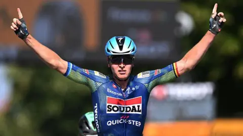 Tim Merlier celebrates winning stage eight of the 2026 Tour de France