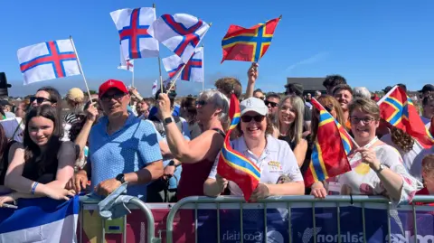 Fans from various islands coming together to watch the opening ceremony