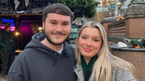 Steve Jones/BBC Harry Franks, who has short dark hair and short facial hair, and Sophie Turner, who has long blonde hair and a nose piercing.