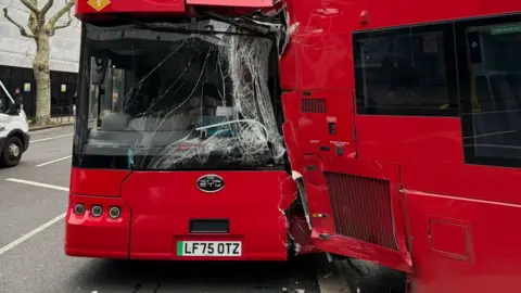 X/Andrew Learmonth A second red bus can be seen having smashed into the back of the other red bus