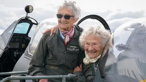 GARETH FULLER/PA WIRE Ms Hall and Ms Barron sat in a Spitfire on Thursday