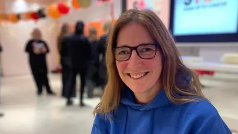 Veronica Currie in a blue hoodie at a workshop 