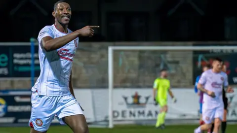 Pacemaker press Man celebrating playing football in a white and red striped football kit