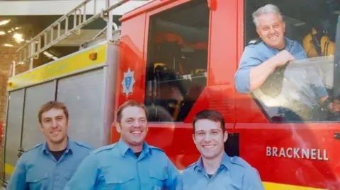 An old pictured of David Hedger in the driving seat of a fire engine during his career at the Royal Berkshire Fire and Rescue Service
