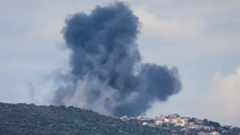 Reuters Smoke billows from the site of Israeli strikes in southern Lebanon. Photo: 22 March 2025