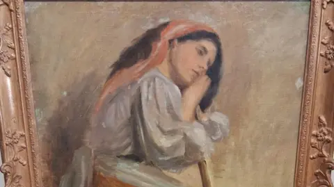 A painting believed to be by artist Stanhope Alexander Forbes. It shows a woman sat on a stool leaning on a broom.