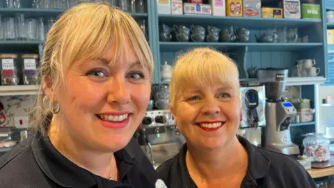 Andrew Turner/BBC Chloe Cashman and Angie Curtis standing at the counter of the Bridgestones Cafe