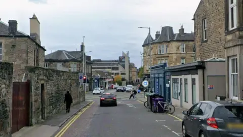 Google Road with cars on it.