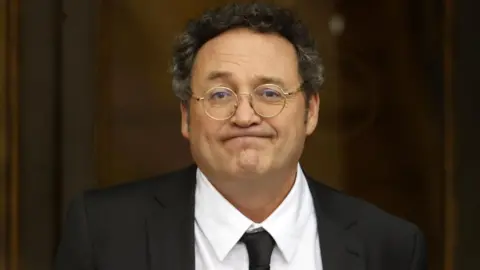 EPA Spanish State Attorney General Alvaro Garcia Ortiz leaves after appearing at the Supreme Court in Madrid. He wears a a dark blazer, white shirt and tie. 