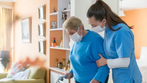 Getty Images Carer with elderly woman