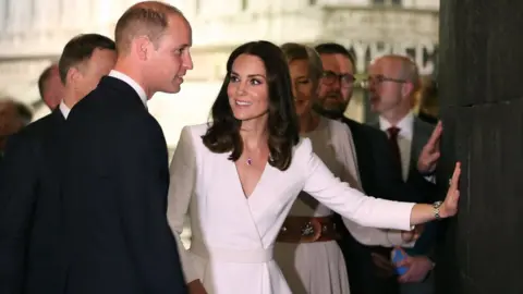 Getty Images Prince William and Catherine put their hands on a pulsating wall